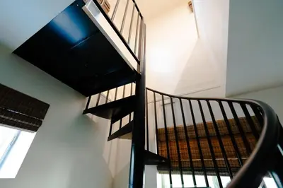 a spiral staircase in a house with a window at Rare Stay Inside Yosemite NP w Hot Tub, AC, WiFi in Wawona