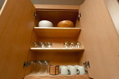 a cupboard with some bowls and other items in it at Rare Stay Inside Yosemite NP w Hot Tub, AC, WiFi in Wawona