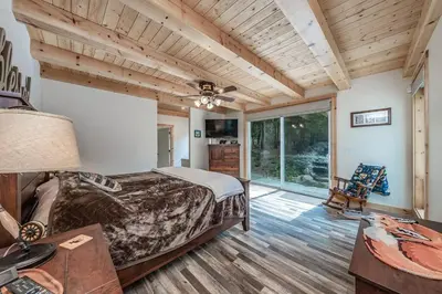 a bedroom with a bed and a wooden ceiling at Multi-Family Villa-private spa waterfall in Shaver Lake