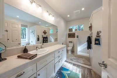 a white bathroom with a sink and a toilet at Multi-Family Villa-private spa waterfall in Shaver Lake