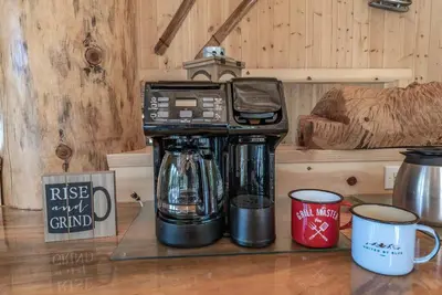 a coffee maker sitting on a counter with two coffee cups at Multi-Family Villa-private spa waterfall in Shaver Lake