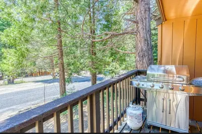 a grill on a balcony with a view of trees at Little Ski Lodge-Across from Spa & Sauna in Shaver Lake
