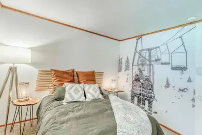 a bedroom with a bed with a drawing on the wall at Little Ski Lodge-Across from Spa & Sauna in Shaver Lake