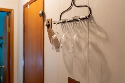 a group of wine glasses hanging on a wall at Smoke Tree-Newly Updated Family Retreat in Shaver Lake