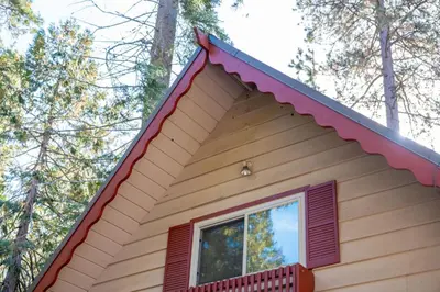 a house with a red roof and a window at Smoke Tree-Newly Updated Family Retreat in Shaver Lake