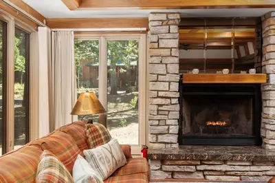 a living room with a couch and a fireplace at Single level Family cabin-Fenced in yard for pets & kids in Shaver Lake