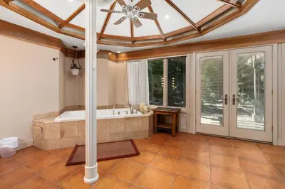 a large bathroom with a tub and a ceiling at Single level Family cabin-Fenced in yard for pets & kids in Shaver Lake
