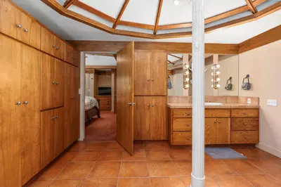 a bathroom with wooden cabinets and a sink at Single level Family cabin-Fenced in yard for pets & kids in Shaver Lake
