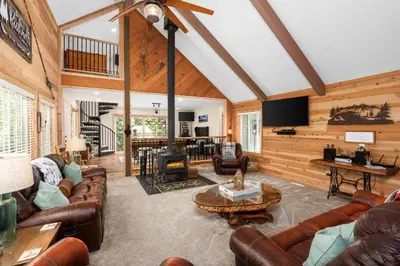 a living room with leather furniture and a fireplace at Cedar Horn- Serene Family Shaver Retreat in Shaver Lake