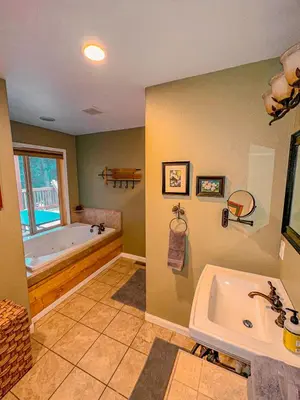 a bathroom with a tub and a sink and a bath tub at Bear Bottoms Family Cabin-Huge GAME ROOM in Shaver Lake