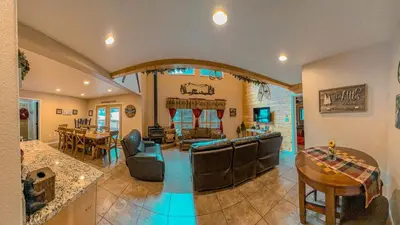 a large living room with a couch and a table at Bear Bottoms Family Cabin-Huge GAME ROOM in Shaver Lake