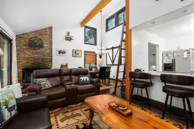 a living room with a couch and a table at Kamp Kokanee-Updated Condo Near Spa Sauna in Shaver Lake