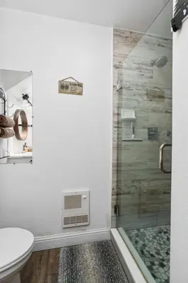 a bathroom with a shower with a toilet and a sink at Kamp Kokanee-Updated Condo Near Spa Sauna in Shaver Lake