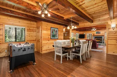 a dining room with a table and chairs in a cabin at Black Diamond-Family Pet Friendly & Near China Peak in Big Creek