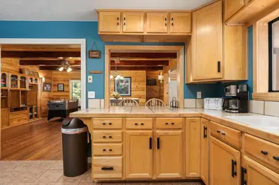 a kitchen with wooden cabinets and a large island at Black Diamond-Family Pet Friendly & Near China Peak in Big Creek