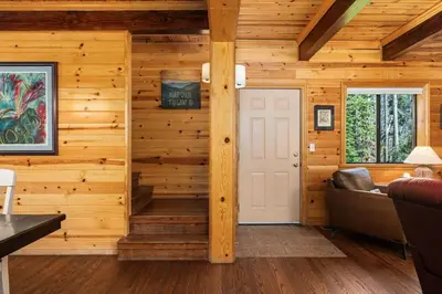 a living room with wooden walls and a white door at Black Diamond-Family Pet Friendly & Near China Peak in Big Creek