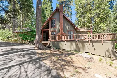 a home with a wrap around porch and a wrap around deck at Wyldwood-Family Friendly-LOFT & BAR in Shaver Lake