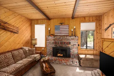 a living room with a couch and a fireplace at Wyldwood-Family Friendly-LOFT & BAR in Shaver Lake