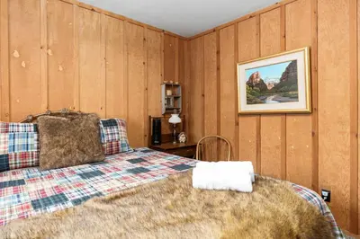 a bedroom with a bed and a picture on the wall at Wyldwood-Family Friendly-LOFT & BAR in Shaver Lake