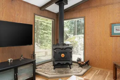a living room with a stove and a tv at Happy Bear- Family & Pet Friendly in Shaver Lake