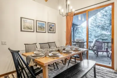 a dining room with a wooden table and chairs at Snowcreek V 870 in Mammoth Lakes