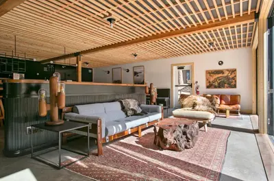 a living room with two couches and a wooden ceiling at The Coachman Hotel in South Lake Tahoe