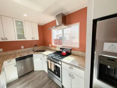 a kitchen with orange walls and a stove top oven at Charming Lake Tahoe Getaway 30 Plus Days Bookings Only Accepted in Zephyr Cove