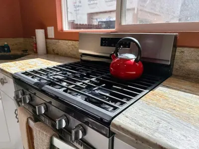 a red tea kettle sitting on a stove in a kitchen at Charming Lake Tahoe Getaway 30 Plus Days Bookings Only Accepted in Zephyr Cove