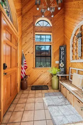 an empty room with a door and a flag at Apple Blossom Lodge-Family Friendly Cabin in Shaver Lake