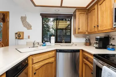 a kitchen with a sink and a dishwasher at Kokanee Hideaway-Family Friendly 5BR Epic Game Room in Shaver Lake