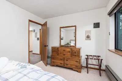 a bedroom with a wooden dresser and a mirror at Kokanee Hideaway-Family Friendly 5BR Epic Game Room in Shaver Lake