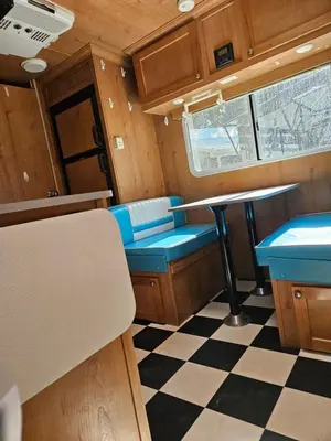 a kitchen with a table and a checkered floor at Gold Rush Historical Resort in Sonora
