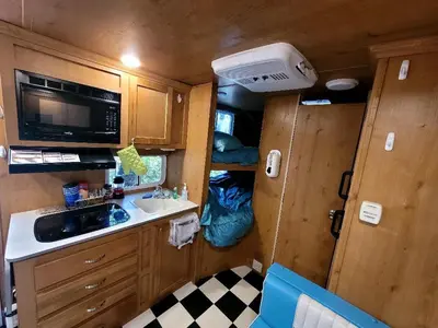 a small kitchen in an rv with a sink and a microwave at Gold Rush Historical Resort in Sonora