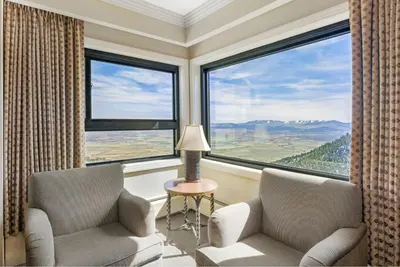 a room with two chairs and a large window at Enjoy the Ridge Tahoe Two-Bedroom Lock-Off for a family of 6 in Stateline