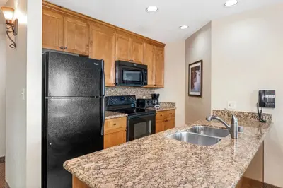 a kitchen with a black refrigerator and a sink at Enjoy the Ridge Tahoe Two-Bedroom Lock-Off for a family of 6 in Stateline