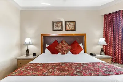 a bedroom with a large bed with red pillows at Enjoy the Ridge Tahoe Two-Bedroom Lock-Off for a family of 6 in Stateline