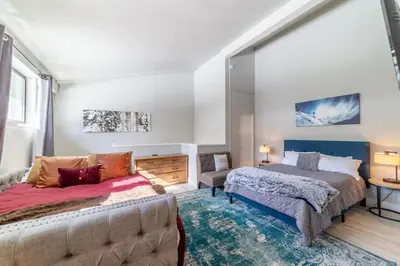 a bedroom with two beds and a couch at Guest Favorite Spacious Remodeled 2 Bdrm 2 Ba Mountain Views in Mammoth Lakes
