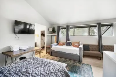 a bedroom with a bed and a couch at Guest Favorite Spacious Remodeled 2 Bdrm 2 Ba Mountain Views in Mammoth Lakes