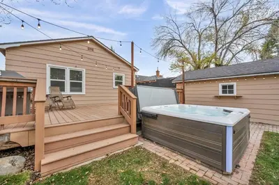 a hot tub on a deck next to a house at New-Near Midtown-HotTub-Firepit-Arlington Manor in Reno
