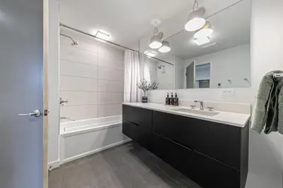 a bathroom with a sink and a tub and a mirror at Starfall Run at Palisades by Tahoe Getaways - Luxury 3BR w Ski Shuttle, A/C & Bonus Room! in Alpine Meadows