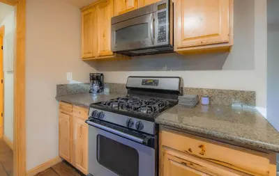 a kitchen with a stove and a microwave at The Heavenly Foothills For 4 in South Lake Tahoe