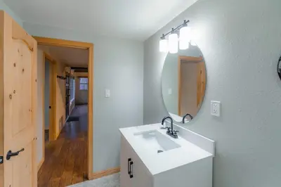 a bathroom with a white sink and a mirror at The Heavenly Foothills For 4 in South Lake Tahoe
