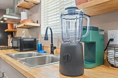 a blender sitting on a counter next to a sink at Boho Chic Dt Visalia W Modern Art Flair in Visalia