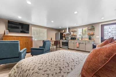 a kitchen and living room with a bed and chairs at Boho Chic Dt Visalia W Modern Art Flair in Visalia