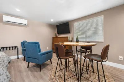 a room with a table and chairs and a bed at Boho Chic Dt Visalia W Modern Art Flair in Visalia
