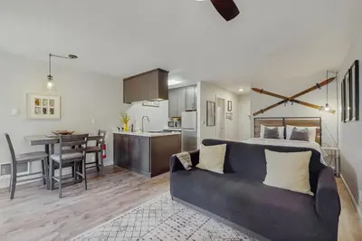 a living room and kitchen with a couch and a table at Cozy Kings Run Condo in Tahoe Vista