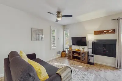 a living room with a couch and a flat screen tv at Cozy Kings Run Condo in Tahoe Vista