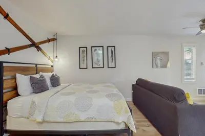 a bedroom with a bed and a couch at Cozy Kings Run Condo in Tahoe Vista