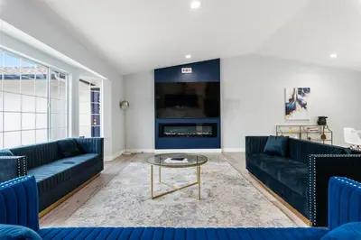 a living room with blue couches and a tv at Amazing Views Hot Tub-Games-Fire pit 6BR Sleeps 20 in Oakhurst