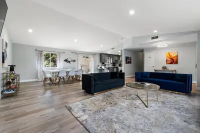 a living room with two blue couches and a table at Amazing Views Hot Tub-Games-Fire pit 6BR Sleeps 20 in Oakhurst
